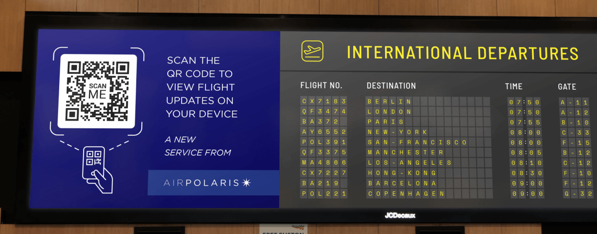 QR Code on an airport departures board prompting people to scan to view flight updates on their mobile phones.