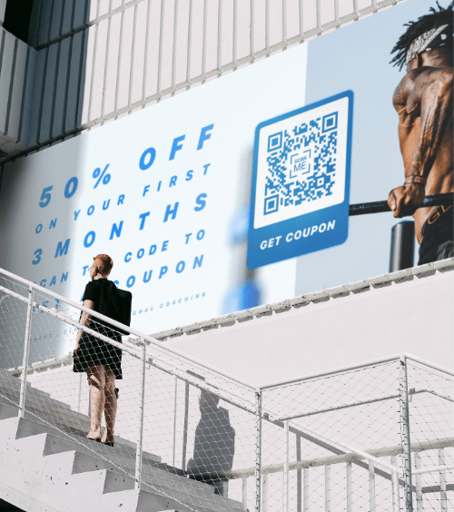 An outdoor billboard from a gym that advertises a promotion with a QR Code that offers a discount coupon when scanned.
