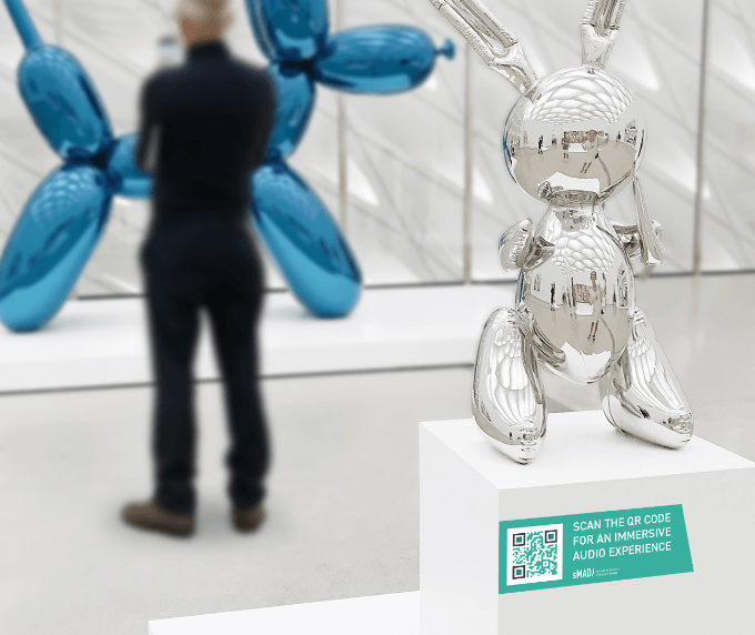 QR Code on a statue promoting an immersive audio experience.