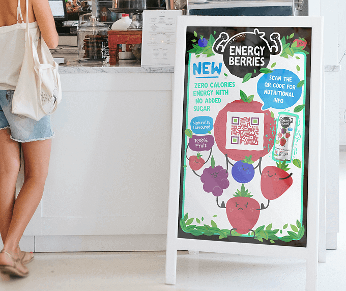 A sandwich board sign at a cafe with a QR Code that shows nutritional information of an energy drink in a PDF file.