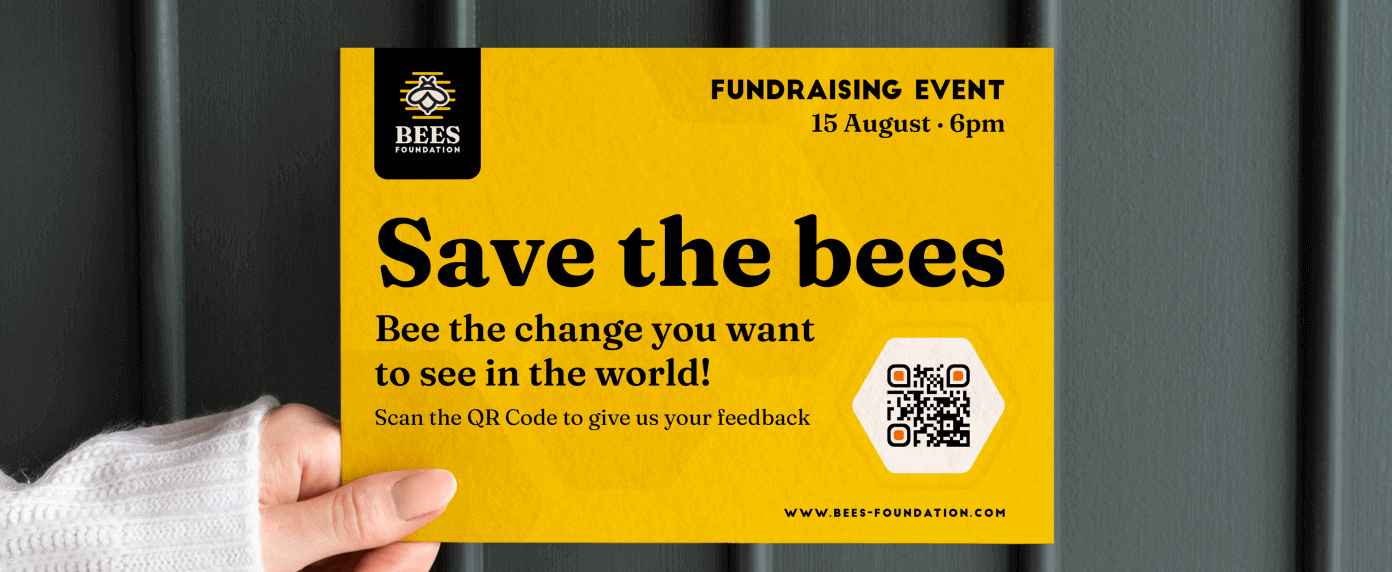 A hand holding up a flyer for a fundraising event to help save the bees.