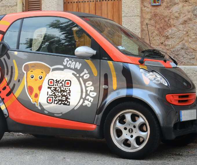 Food delivery vehicle with a QR Code that links to a food ordering platform.