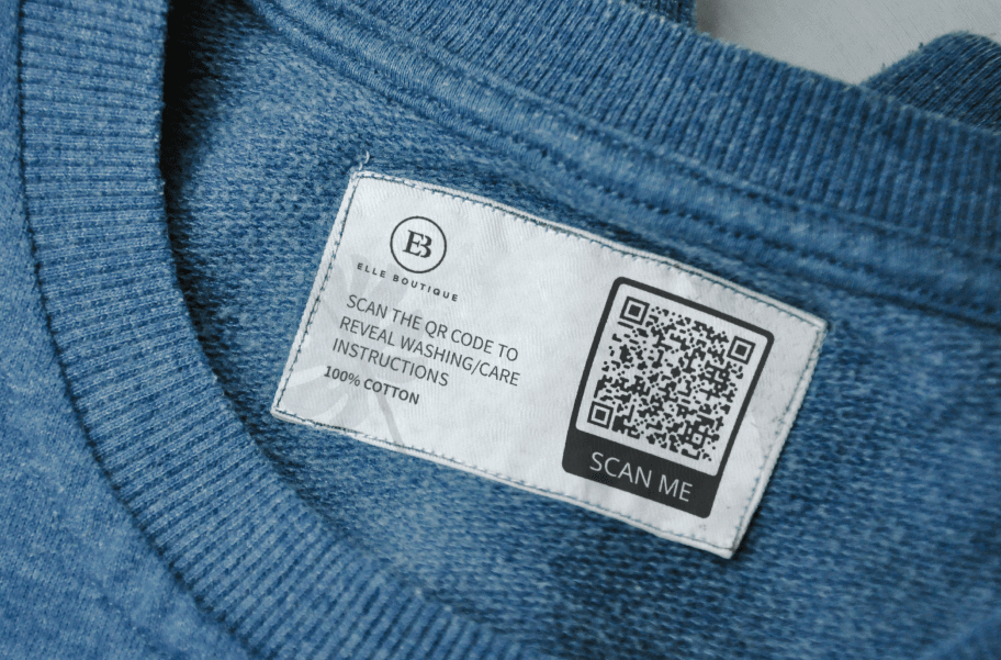 A tag on the collar of a blue shirt showing a 2D Barcode that leads to washing and care instructions.